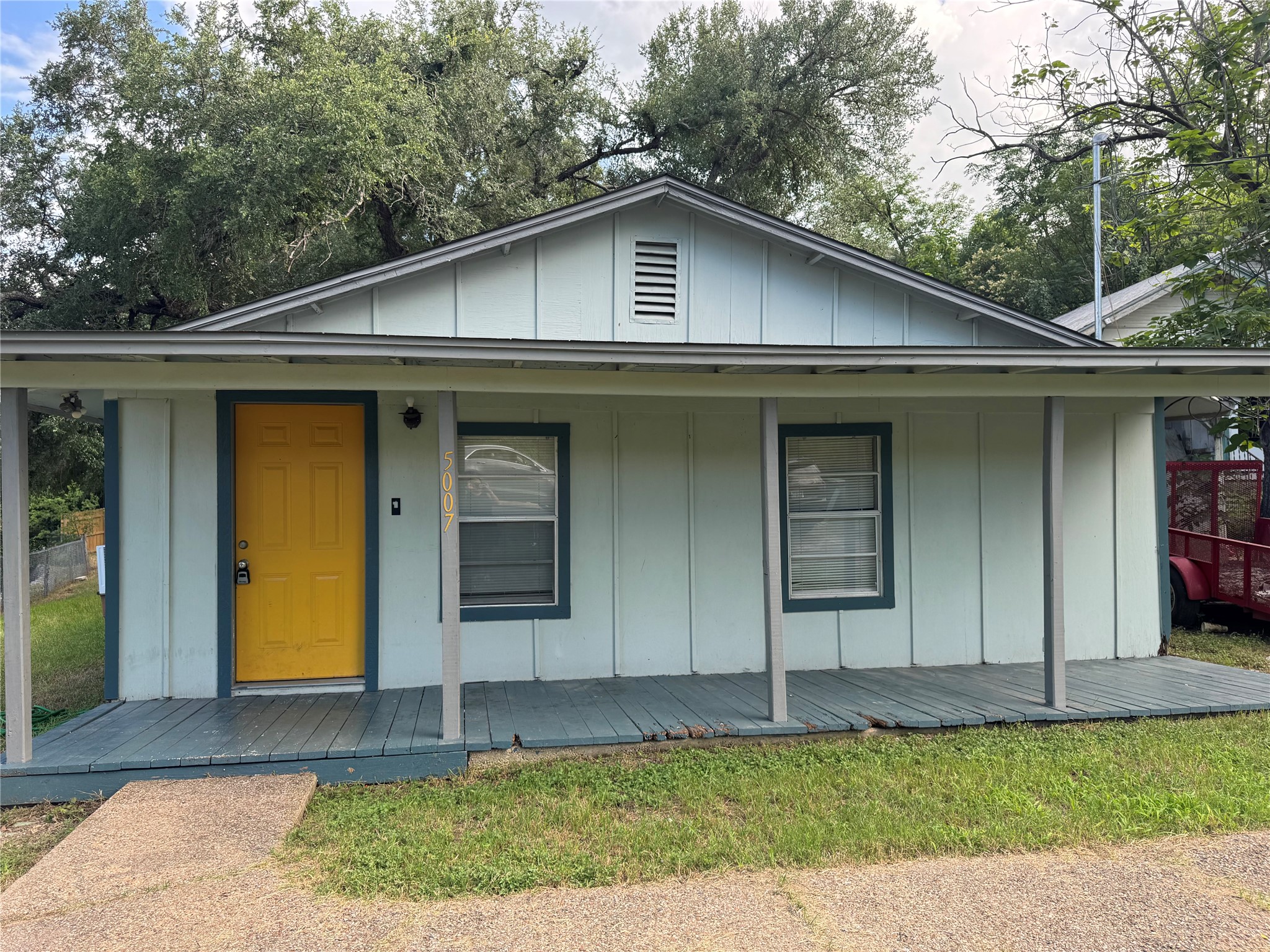 5007 Heflin Lane Austin, TX 78721 - Photo 2 of 25 A charming cottage facade, highlighted by a welcoming front porch and vibrant entryway.