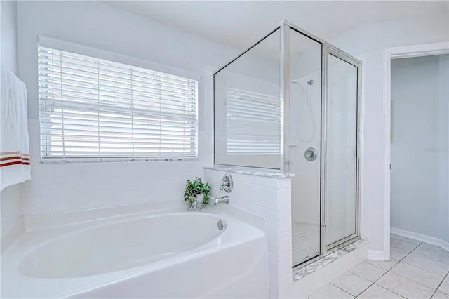 a white bath tub sitting next to a window