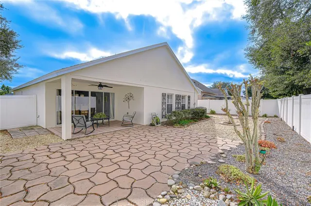 a view of a house with backyard porch and sitting area