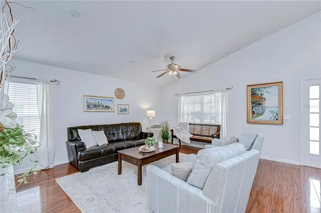 a living room with furniture and a potted plant