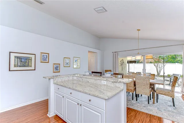 a view of a kitchen counter top space with wooden floor and furniture