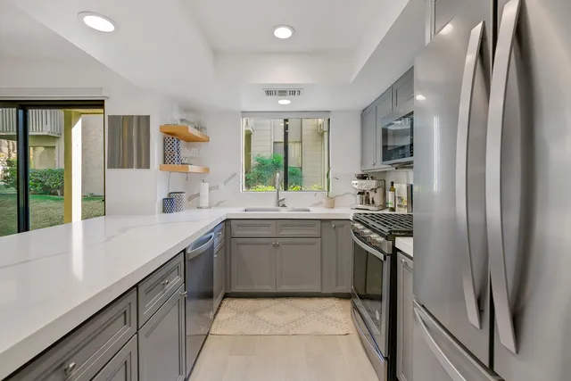 a kitchen with a sink stove and refrigerator