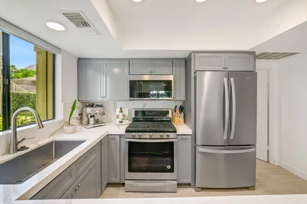 a kitchen with a stove a refrigerator and a sink