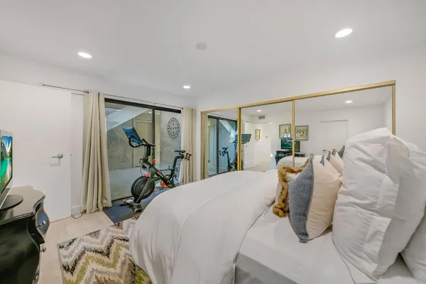 a bedroom with a bed and a mirror