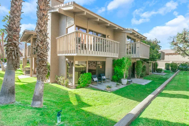 a front view of a house with garden and plants