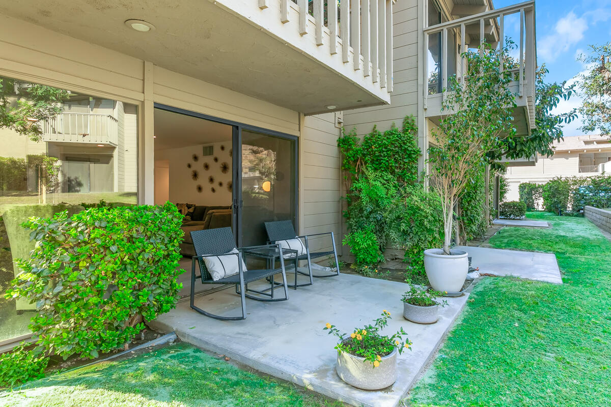 46644 Arapahoe, Unit A Indian Wells, CA 92210 - Photo 26 of 29 a view of a chair and table in backyard of the house