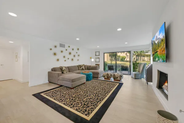 a living room with fireplace furniture and a flat screen tv