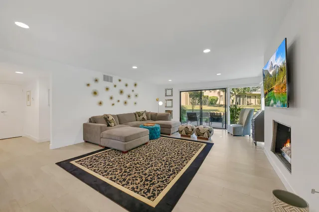 a living room with fireplace furniture and a flat screen tv