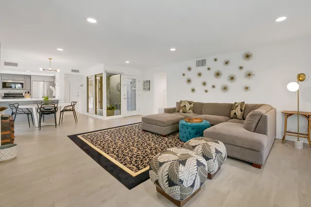 a living room with furniture rug and window