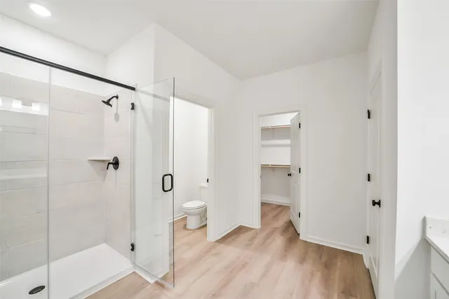 a bathroom with a shower and toilet