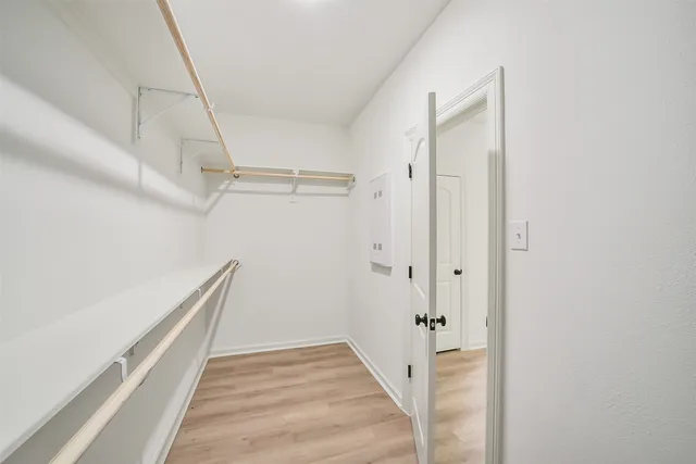 a view of a hallway with wooden floor and staircase