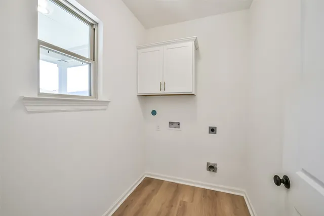 a view of a room with wooden floor and cabinet