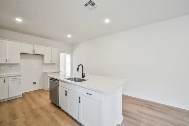 a kitchen with a sink stainless steel appliances and cabinets