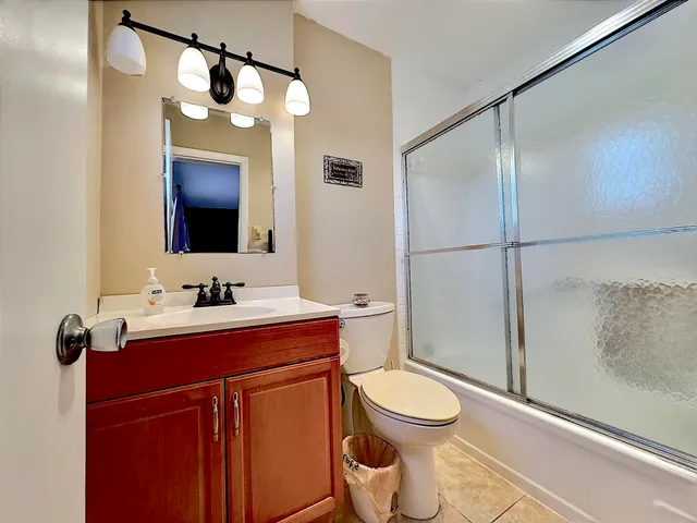 a bathroom with a toilet a sink and a mirror