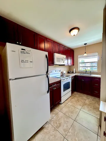 a kitchen with a refrigerator and a dishwasher