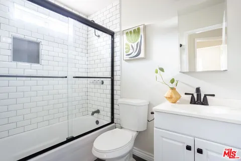 a white toilet sitting next to a bathroom sink