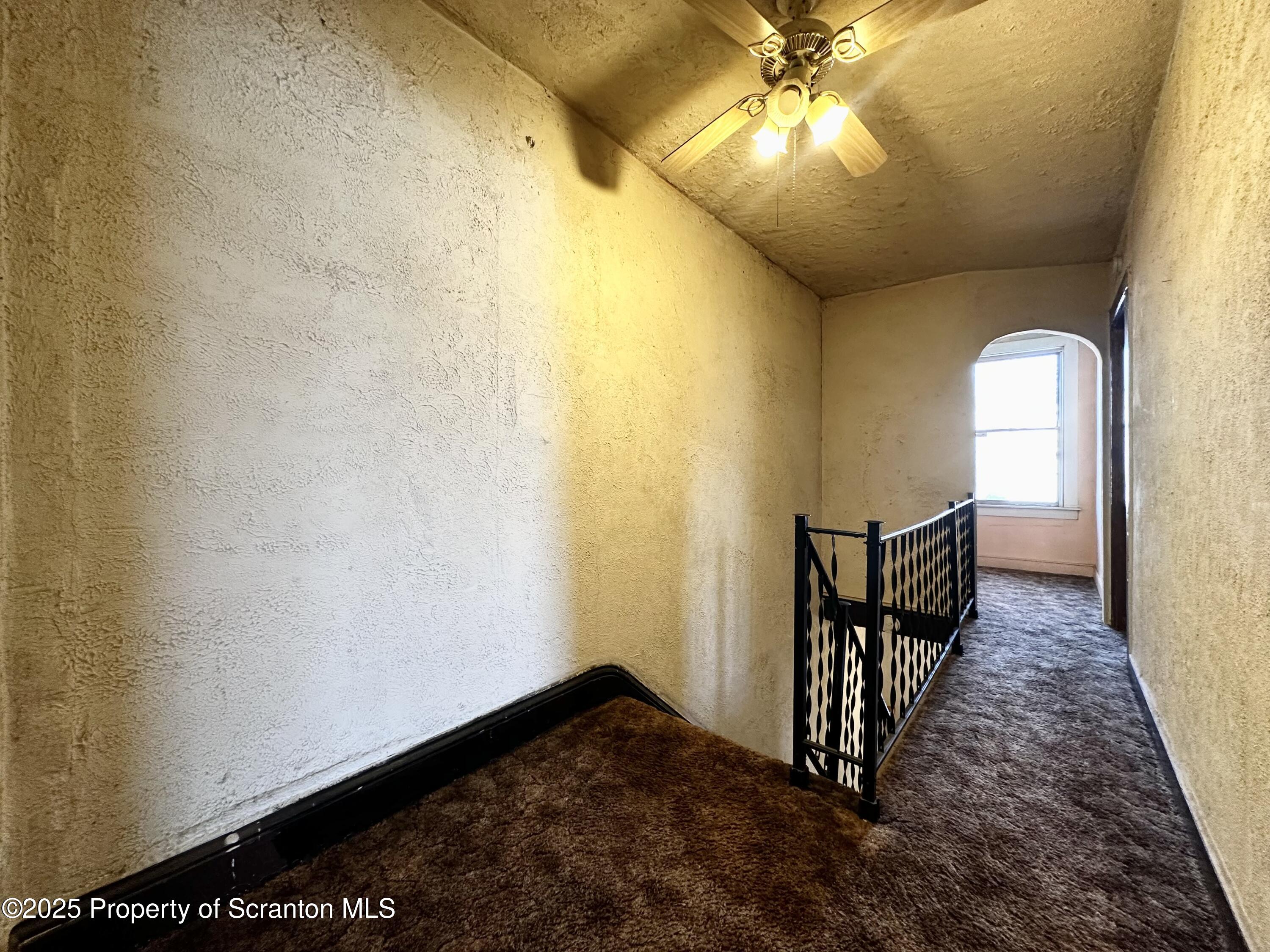514 East Market Street Scranton, PA 18509 - Photo 11 of 33 a view of a hallway with wooden floor and chandelier