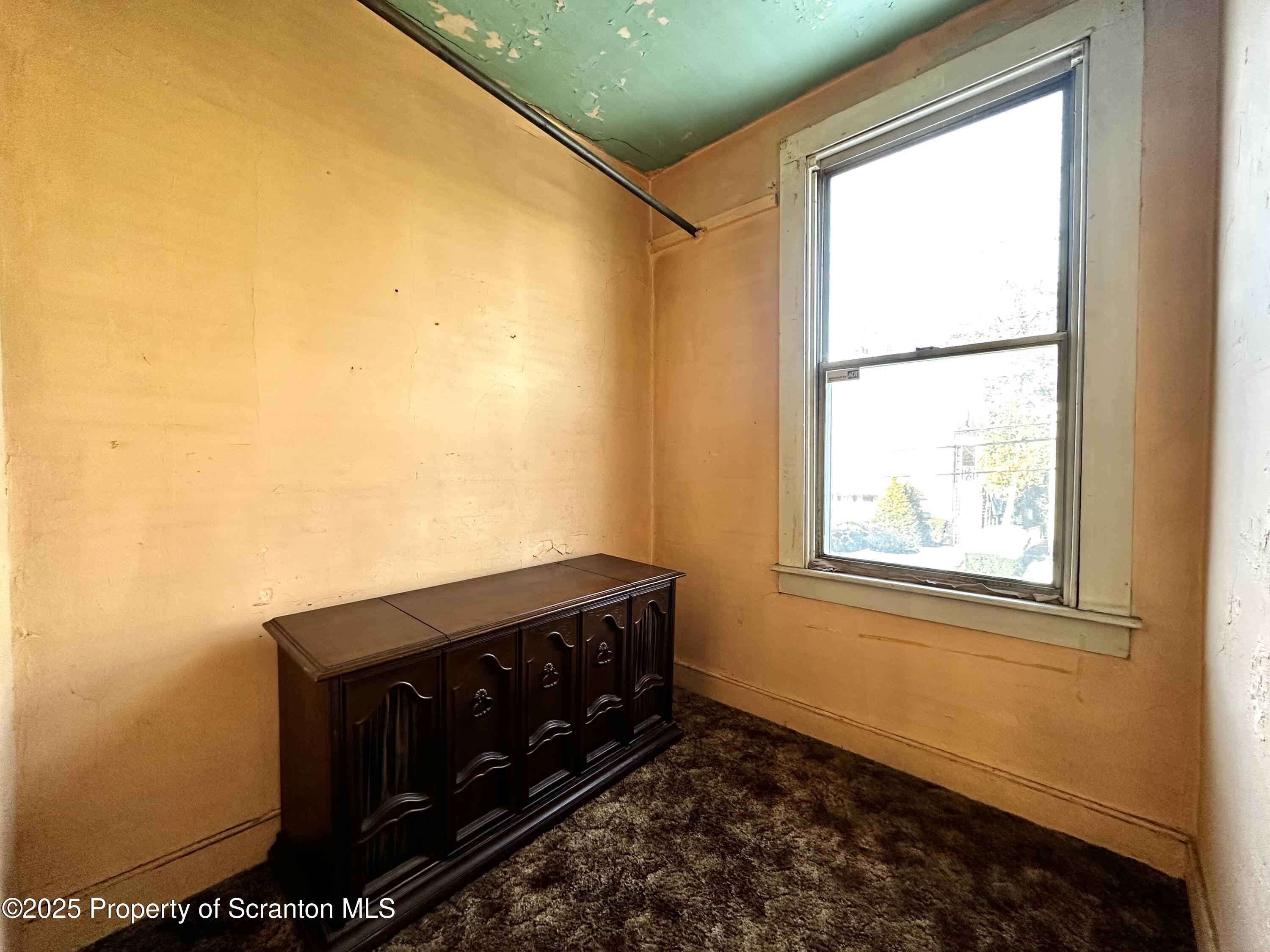 514 East Market Street Scranton, PA 18509 - Photo 14 of 33 a view of a bedroom with wooden floor and a window