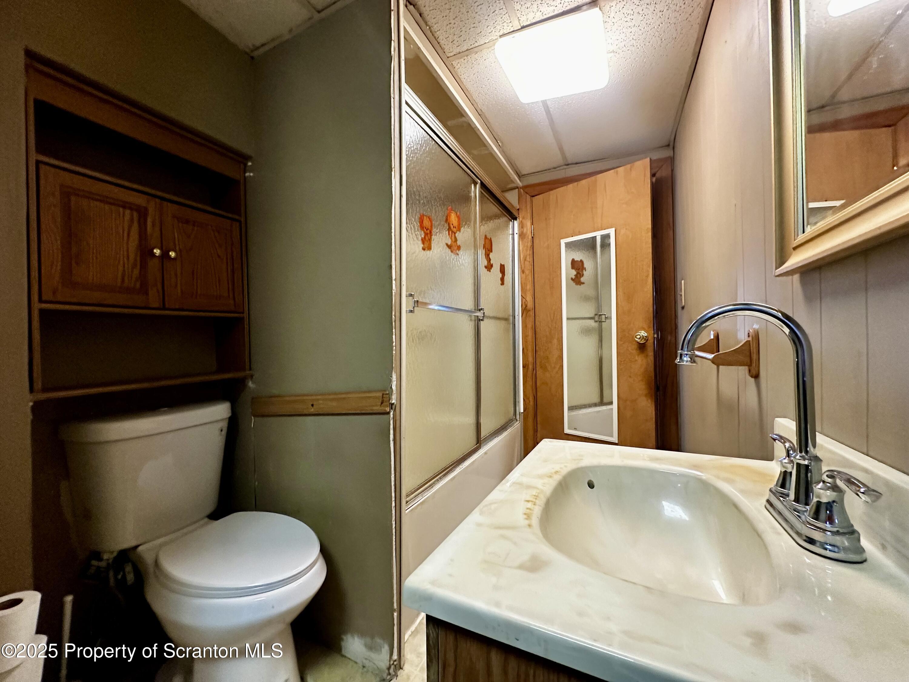 514 East Market Street Scranton, PA 18509 - Photo 15 of 33 a bathroom with a granite countertop toilet sink and mirror