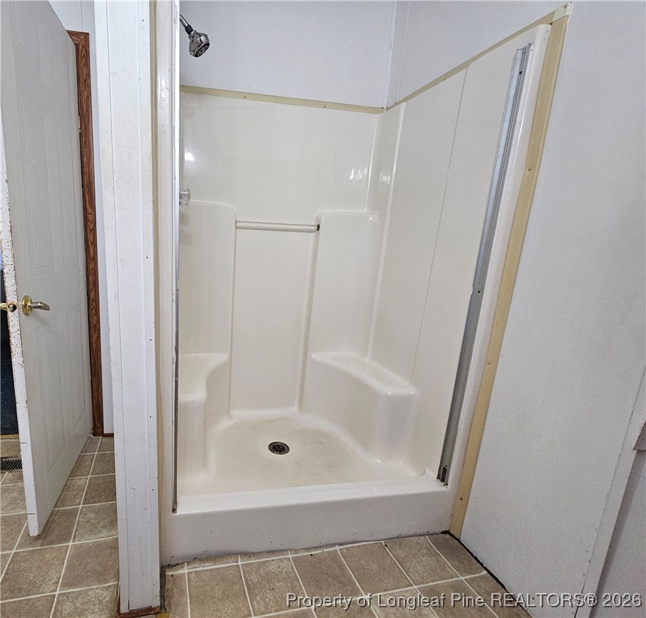 21981 McIntosh Road Wagram, NC 28396 - Photo 14 of 23 a bathroom with a shower