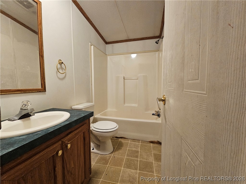 21981 McIntosh Road Wagram, NC 28396 - Photo 19 of 23 a bathroom with a granite countertop sink toilet a mirror a vanity and a shower