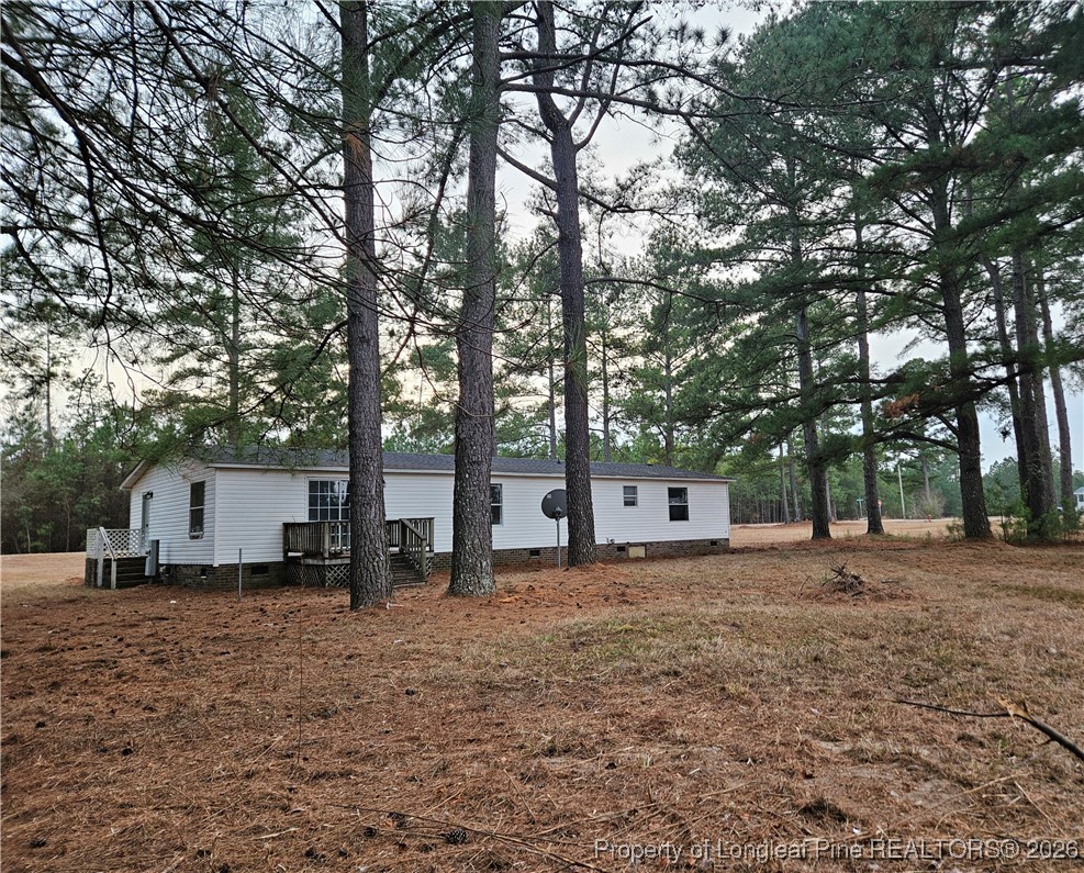 21981 McIntosh Road Wagram, NC 28396 - Photo 20 of 23 a house view with a backyard space