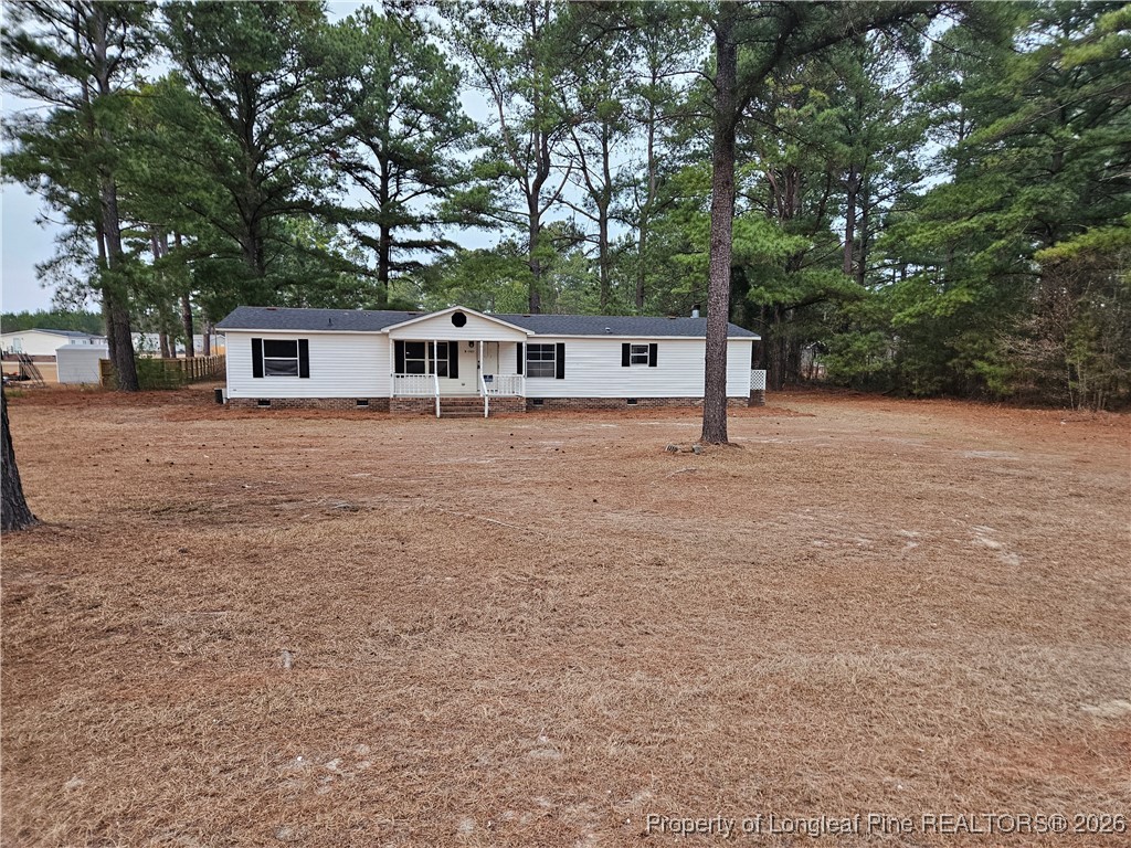 21981 McIntosh Road Wagram, NC 28396 - Photo 2 of 23 front view of a house with a trees
