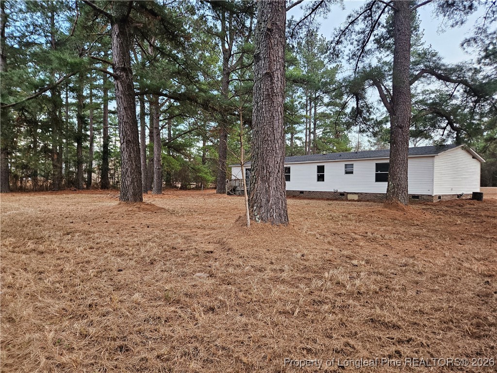 21981 McIntosh Road Wagram, NC 28396 - Photo 21 of 23 a backyard of a house with lots of green space
