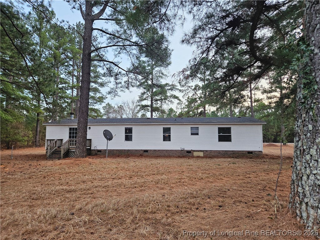 21981 McIntosh Road Wagram, NC 28396 - Photo 22 of 23 a view of a house with a yard