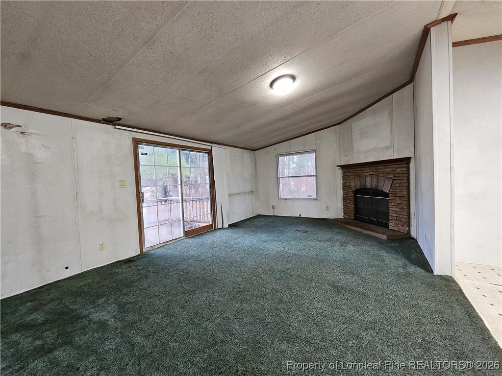 21981 McIntosh Road Wagram, NC 28396 - Photo 8 of 23 a view of empty room with fireplace