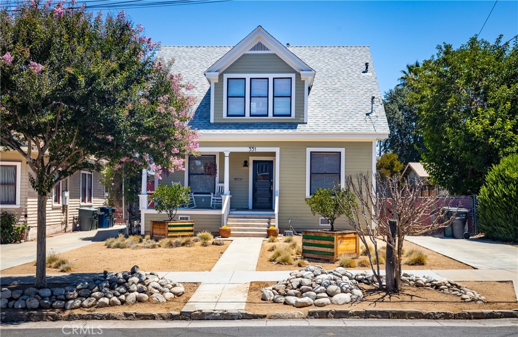 a front view of a house with garden