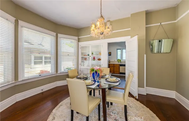 a view of a dining room with furniture wooden floor and chandelier
