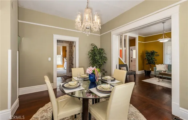 a view of a dining room with furniture wooden floor and chandelier