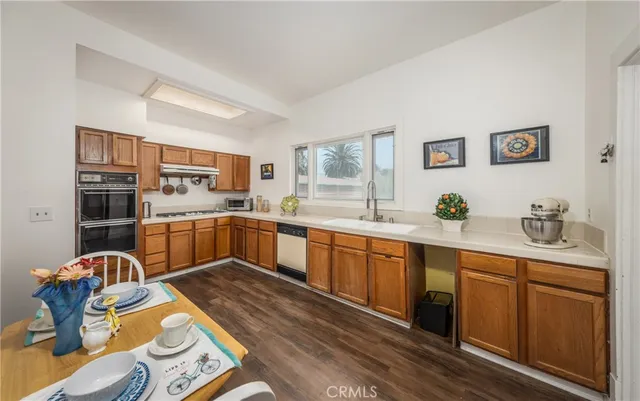 a kitchen with stainless steel appliances granite countertop a sink and cabinets