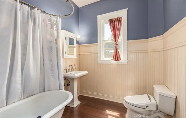 a bathroom with a toilet a sink and a mirror