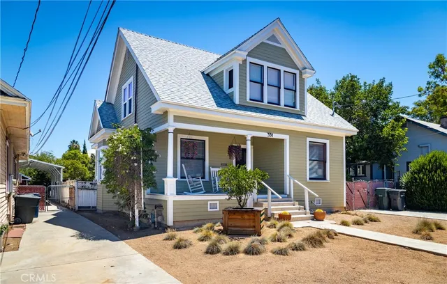 a front view of house with yard outdoor seating and barbeque oven