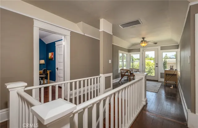 a view of a hallway with living room and dining room
