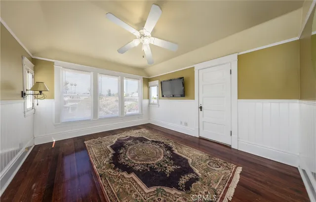 a view of a livingroom with wooden floor and white walls