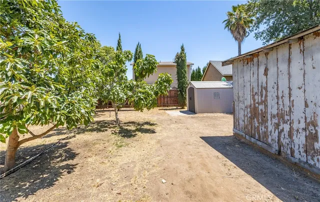 a view of a yard with wooden fence