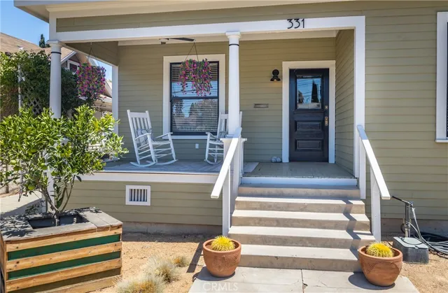 a front view of a house with outdoor seating