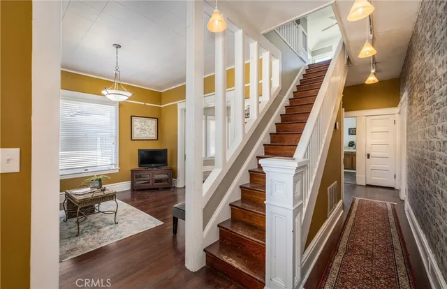 a view of entryway and hall with wooden floor