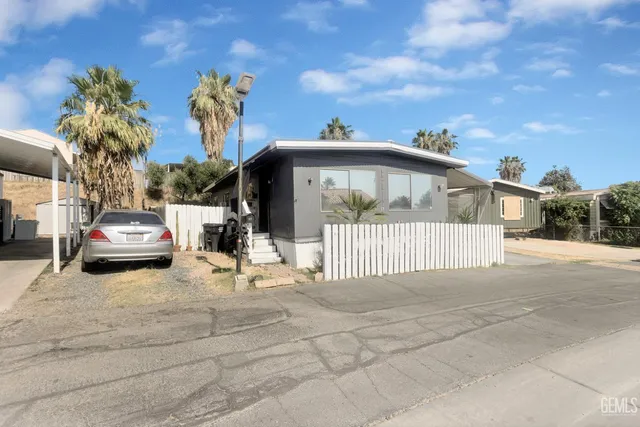 a view of a white house with a sink and yard
