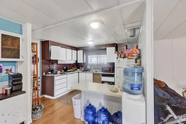 a kitchen with stainless steel appliances granite countertop a stove and a refrigerator