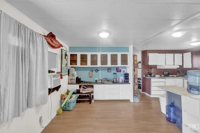 a living room with furniture and a kitchen view