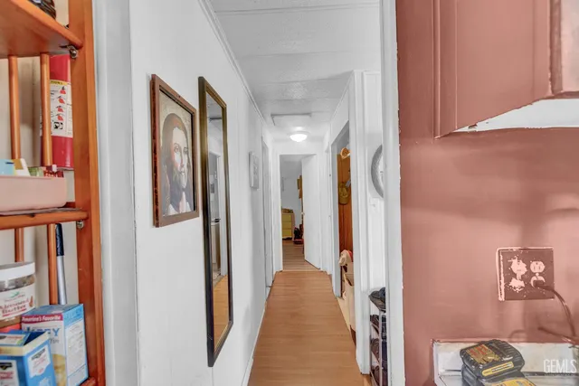 a view of hallway with paintings on the wall