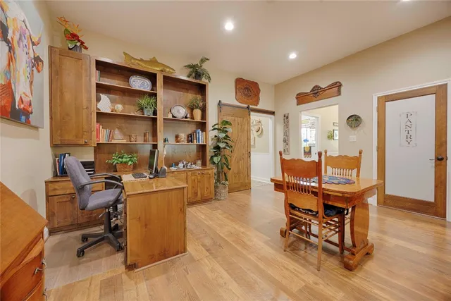 a bathroom with a granite countertop sink a mirror and shower