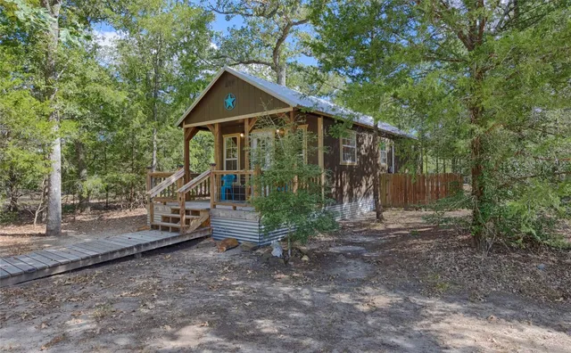 a view of a room with furniture and wooden floor