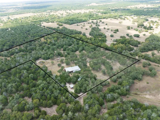 a living room with lots of furniture and kitchen view