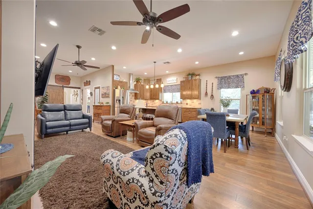a view of cabinets a wooden floor and a refrigerator in a room