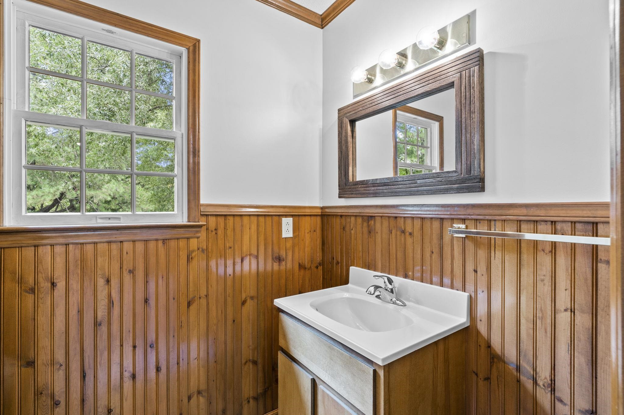 119 Lakeside Circle Willow Spring, NC 27592 - Photo 14 of 37 a bathroom with a sink a mirror and a window